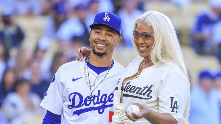 Lizzo throws the first pitch at a baseball game wearing